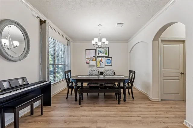a view of a dining room with furniture and chandelier