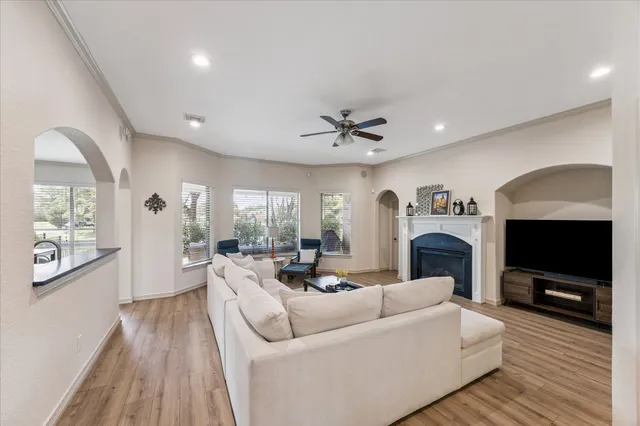 a living room with furniture a fireplace and a flat screen tv