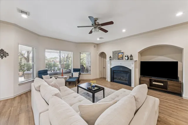 a living room with furniture a fireplace and a flat screen tv