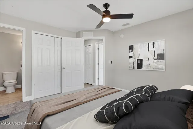 a bedroom with a bed and a painting on the wall