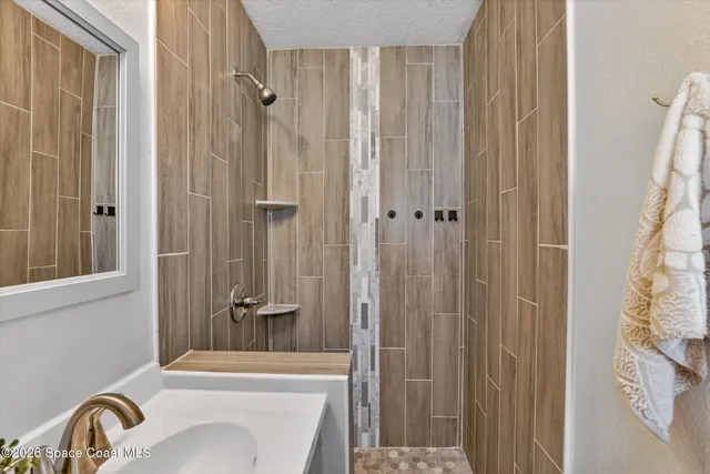 a bedroom with a bed and a potted plant