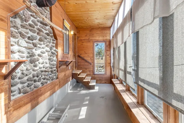 a balcony with outdoor seating and windows