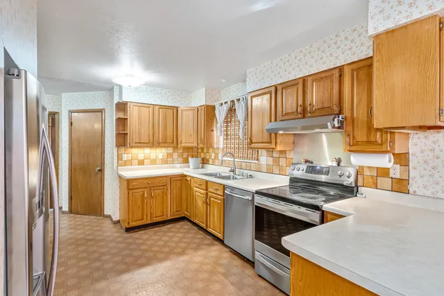 a kitchen with a stove a sink and a refrigerator