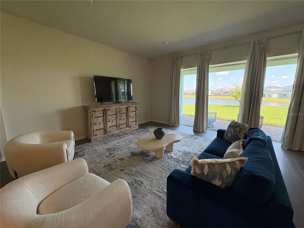 8243 Fenton Street Orlando, FL 32836 - Photo 20 of 35 a living room with furniture and a flat screen tv