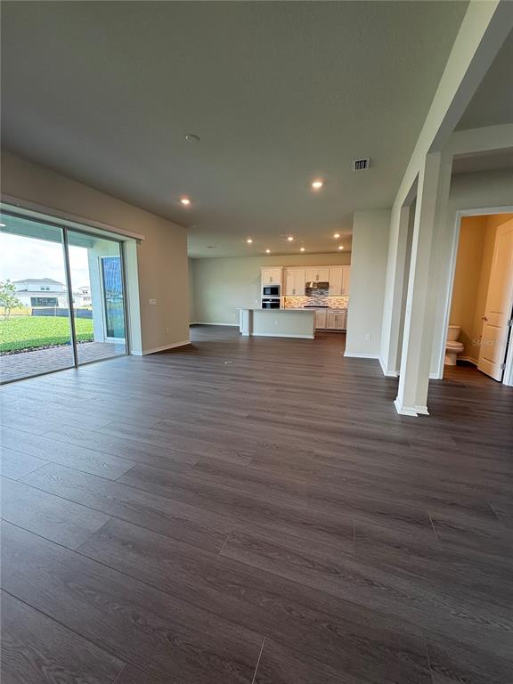 8243 Fenton Street Orlando, FL 32836 - Photo 2 of 35 an empty room with wooden floor and a window
