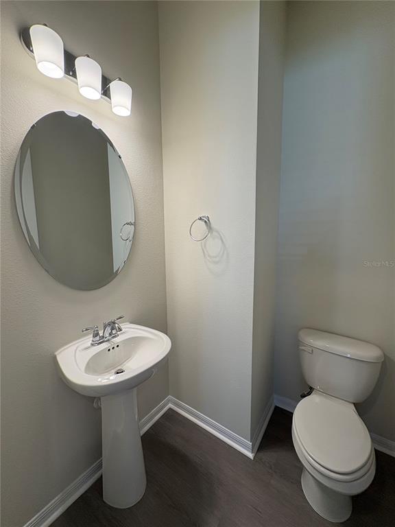 8243 Fenton Street Orlando, FL 32836 - Photo 21 of 35 a bathroom with a toilet sink and mirror