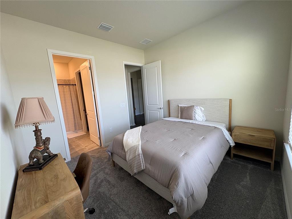 8243 Fenton Street Orlando, FL 32836 - Photo 22 of 35 a bedroom with a bed and a painting