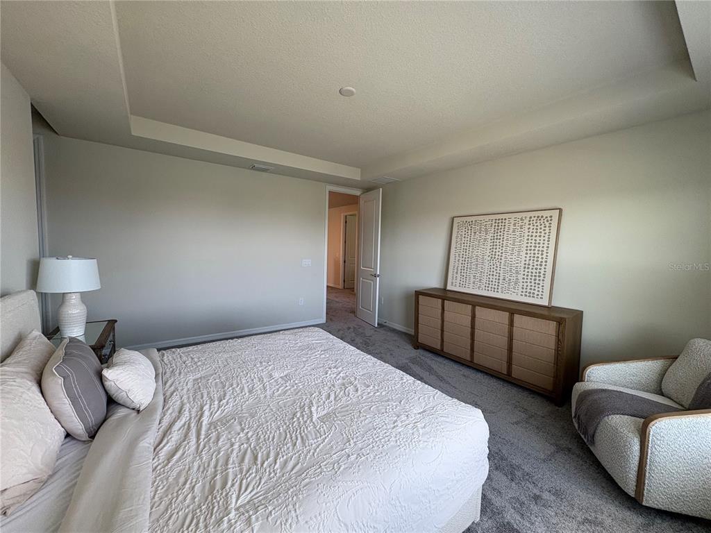 8243 Fenton Street Orlando, FL 32836 - Photo 27 of 35 a bedroom with a bed and a couch