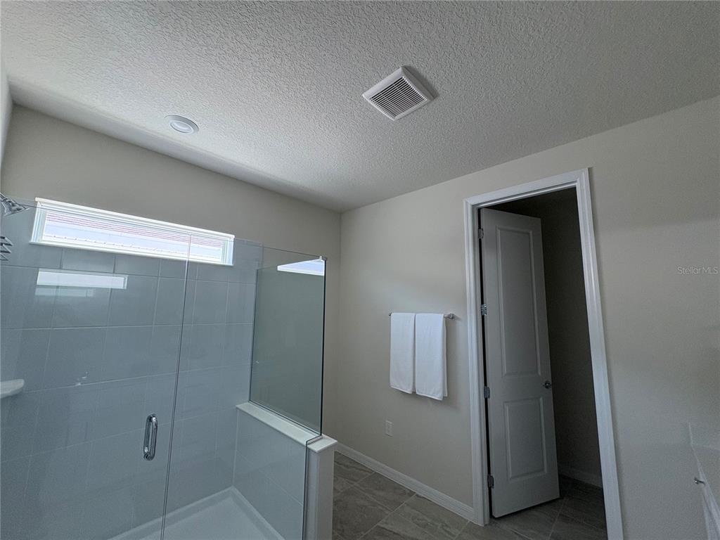 8243 Fenton Street Orlando, FL 32836 - Photo 28 of 35 a bathroom with a shower and closet