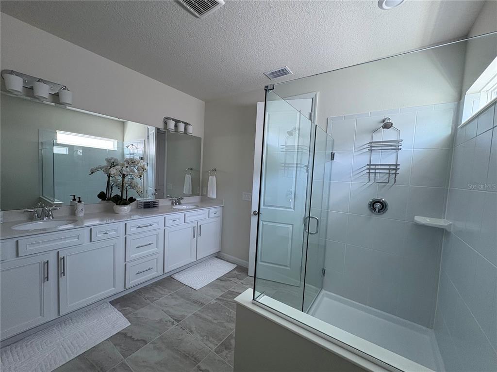 8243 Fenton Street Orlando, FL 32836 - Photo 30 of 35 a bathroom with a shower sink and mirror