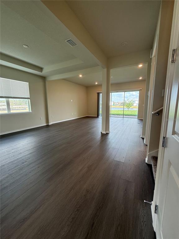 8243 Fenton Street Orlando, FL 32836 - Photo 3 of 35 an empty room with wooden floor and windows