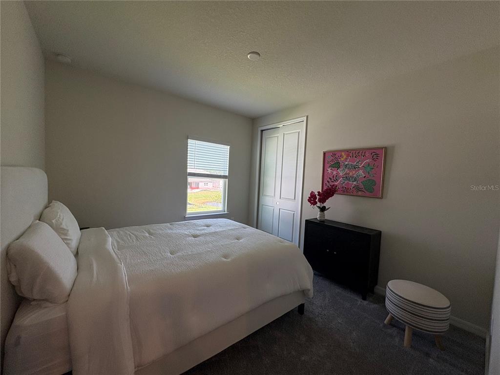 8243 Fenton Street Orlando, FL 32836 - Photo 31 of 35 a bedroom with a bed and a window