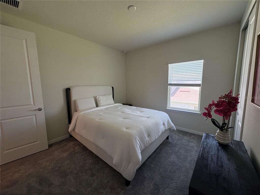 8243 Fenton Street Orlando, FL 32836 - Photo 32 of 35 a bedroom with a bed and a window