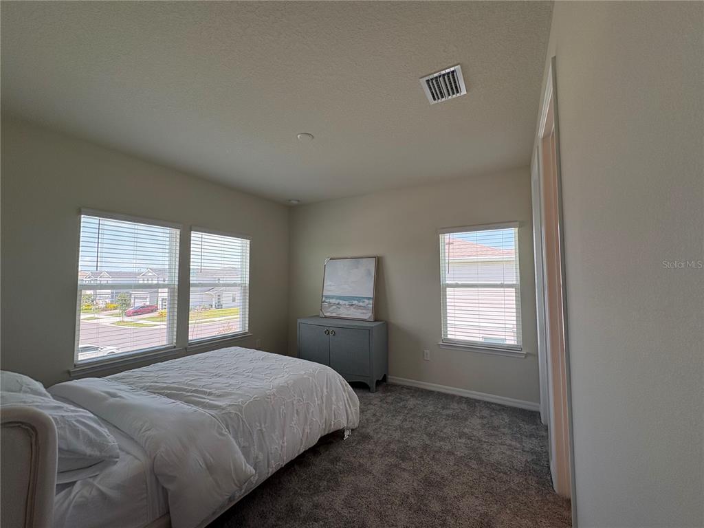 8243 Fenton Street Orlando, FL 32836 - Photo 33 of 35 a bedroom with a bed and a window