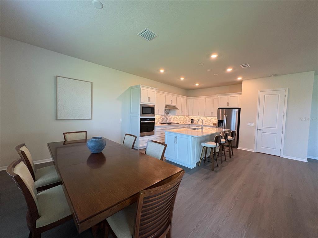 8243 Fenton Street Orlando, FL 32836 - Photo 7 of 35 a view of a dining room with furniture and wooden floor