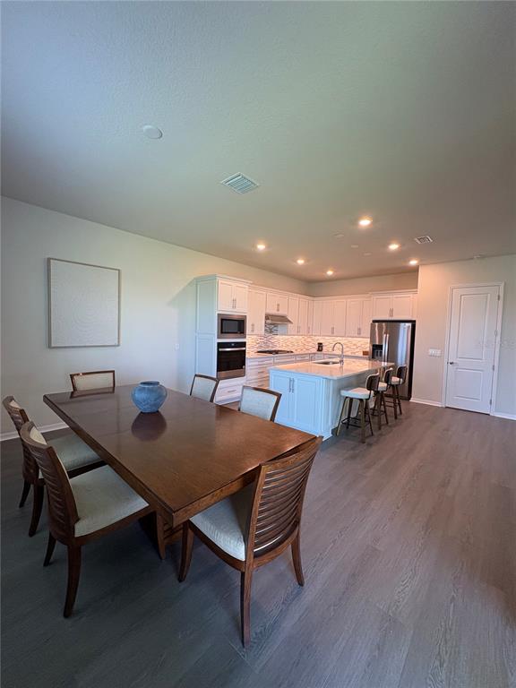 8243 Fenton Street Orlando, FL 32836 - Photo 9 of 35 a view of a dining room with furniture and wooden floor