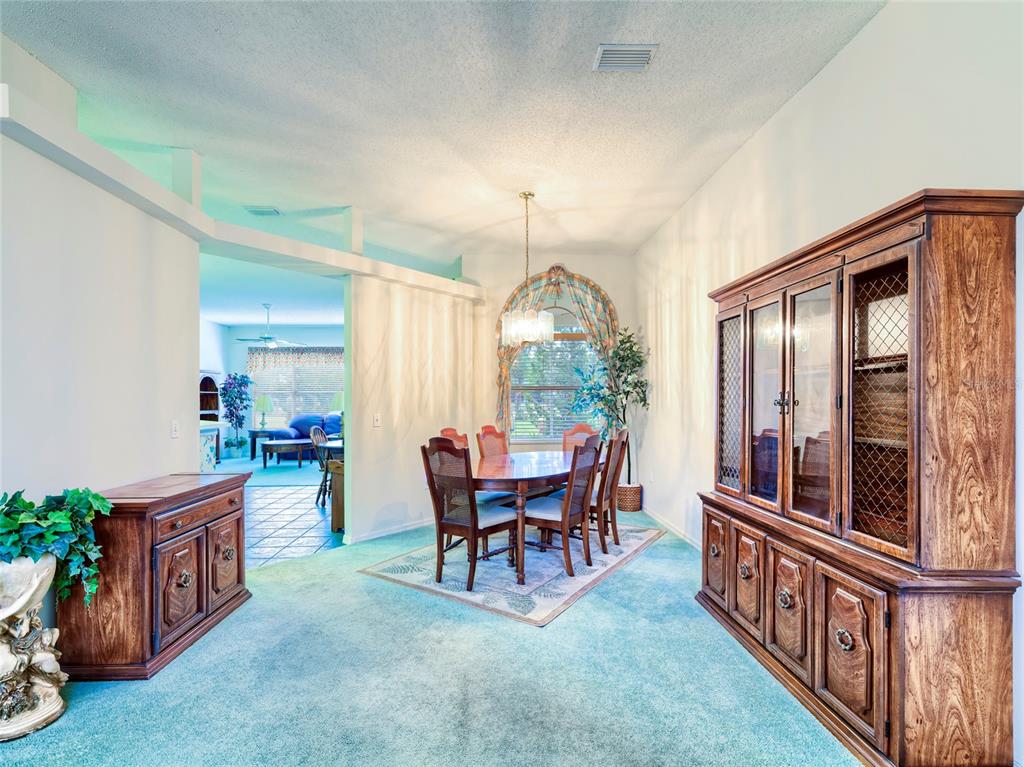11228 Windrush Circle Hudson, FL 34667 - Photo 19 of 67 a dining room with furniture and window