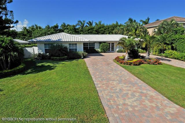 12 Ridge Boulevard Ocean Ridge, FL 33435 - Photo 1 of 13 a front view of a house with garden