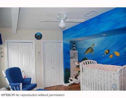 12 Ridge Boulevard Ocean Ridge, FL 33435 - Photo 11 of 13 a living room with furniture and a chandelier