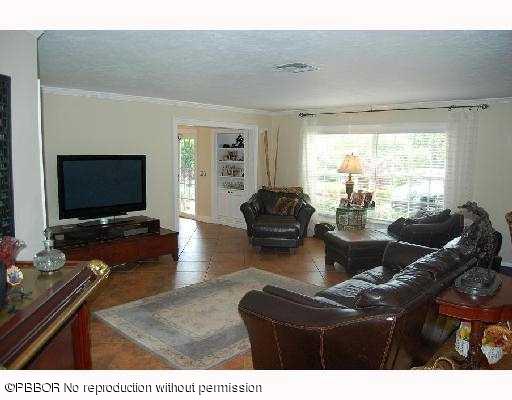 12 Ridge Boulevard Ocean Ridge, FL 33435 - Photo 3 of 13 a living room with furniture and a flat screen tv