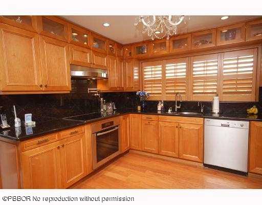12 Ridge Boulevard Ocean Ridge, FL 33435 - Photo 5 of 13 a kitchen with stainless steel appliances granite countertop a stove a sink and a microwave