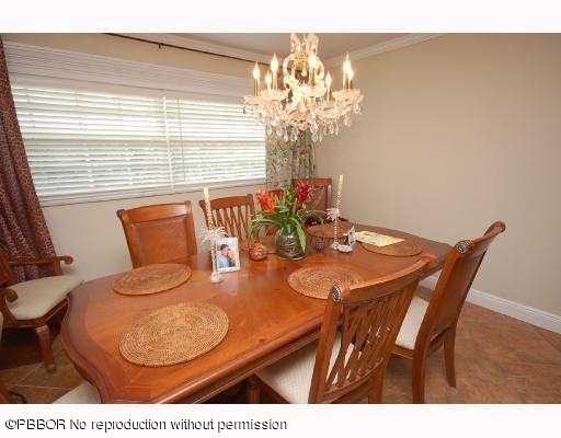 12 Ridge Boulevard Ocean Ridge, FL 33435 - Photo 7 of 13 a view of a dining room with furniture and wooden floor