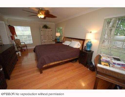12 Ridge Boulevard Ocean Ridge, FL 33435 - Photo 9 of 13 a spacious bedroom with a bed window and dresser