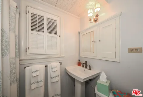 a bathroom with a sink a vanity and a mirror