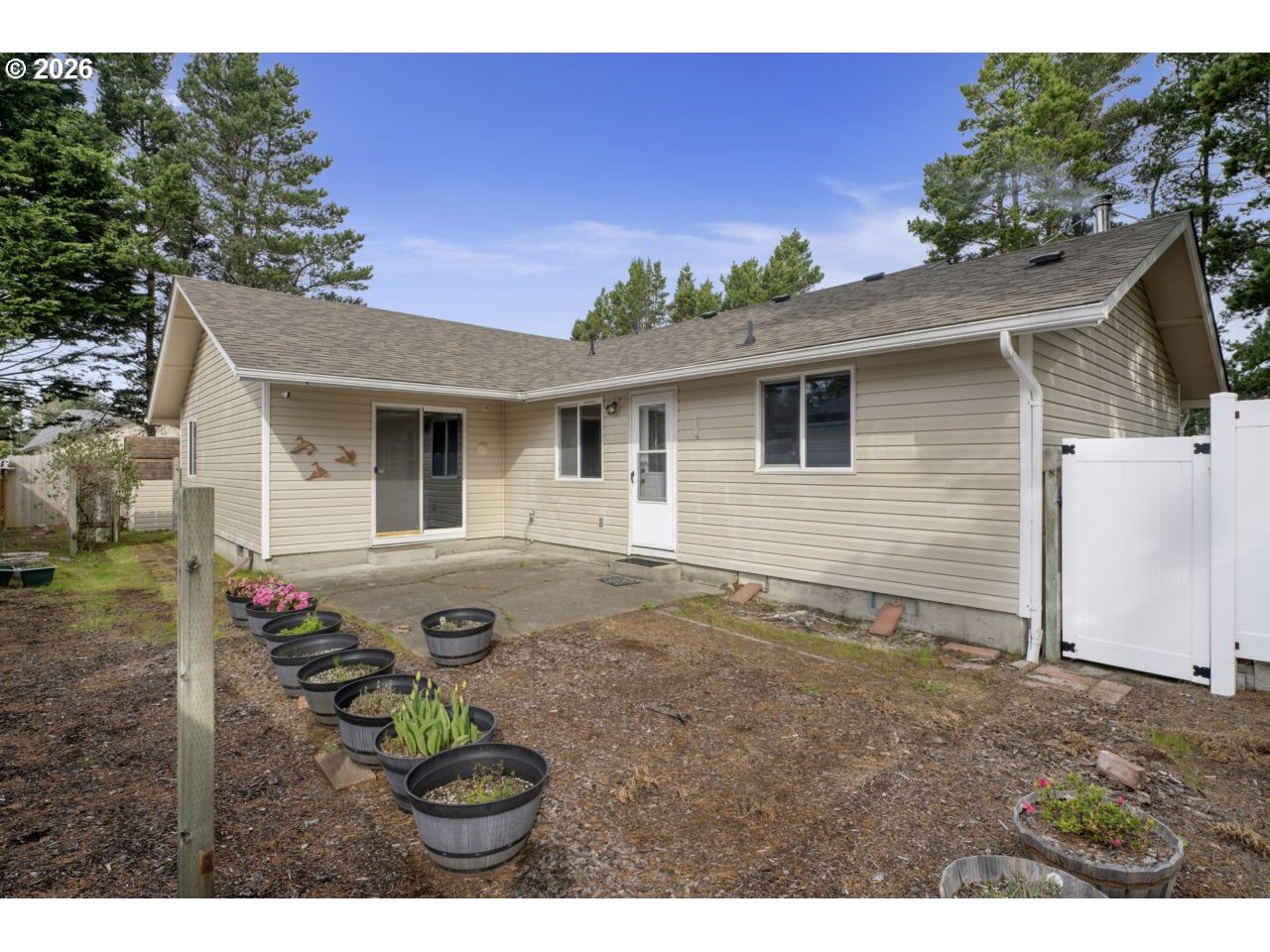 1960 40th Street Florence, OR 97439 - Photo 40 of 48 a view of a house with a backyard