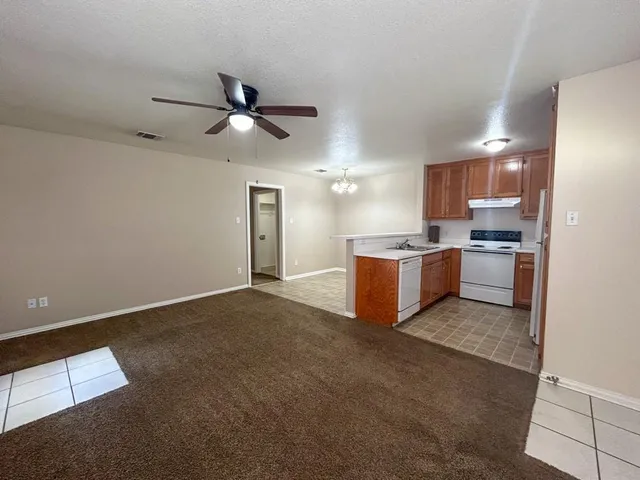 a kitchen with stainless steel appliances granite countertop a sink and a refrigerator