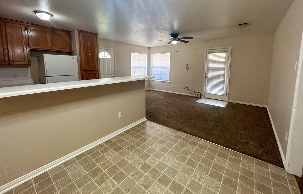 1010 Turkey Creek Court, Unit B Bridgeport, TX 76426 - Photo 4 of 10 an empty room with wooden floor and windows