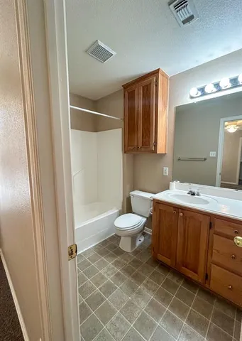 a bathroom with a toilet sink and shower