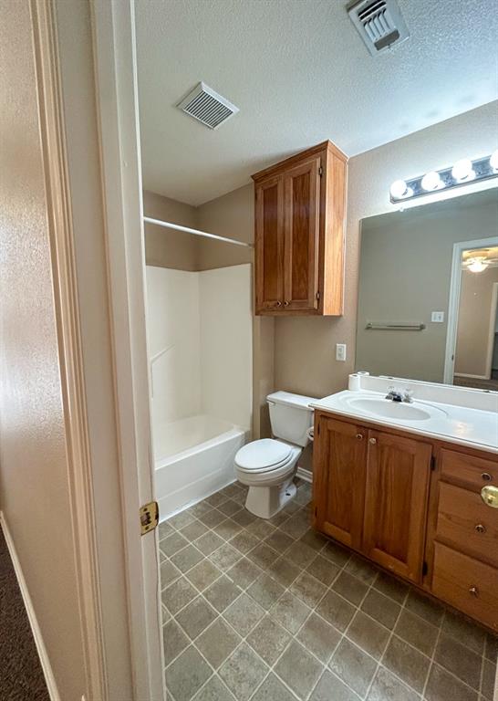 1010 Turkey Creek Court, Unit B Bridgeport, TX 76426 - Photo 5 of 10 a bathroom with a toilet sink and shower