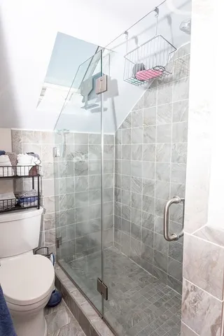 a bathroom with a toilet and shower