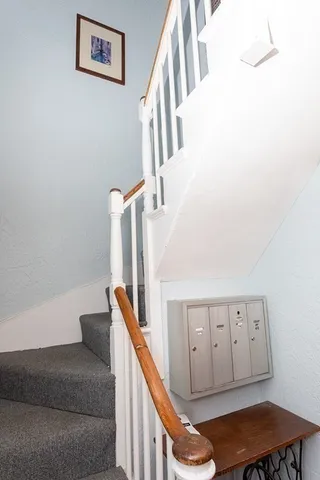 a living room with furniture and stairs