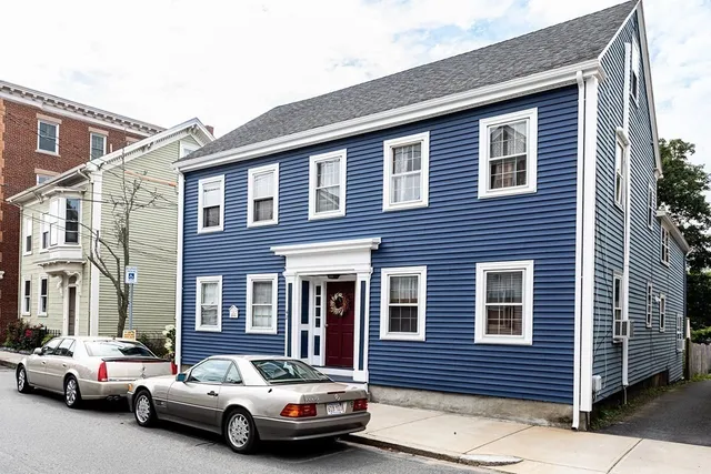 a car parked in front of a brick house