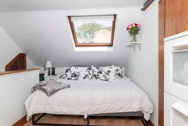 a bedroom with a bed and a potted plant