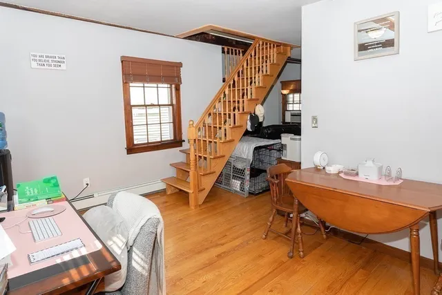 a living room with furniture a rug and a window
