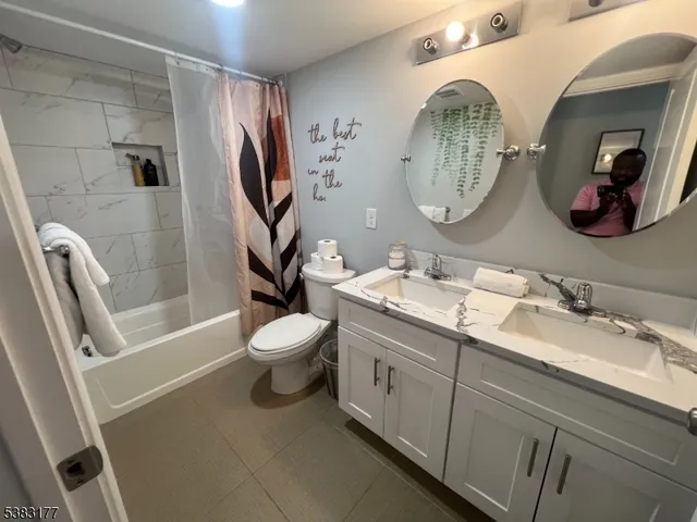 a bathroom with a toilet a sink and a mirror