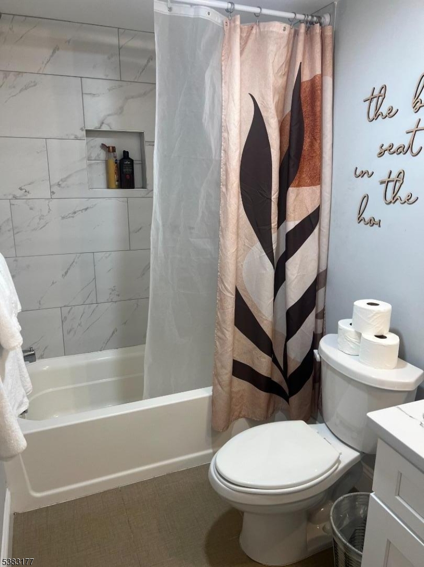 118 Fleming Avenue, Unit 1 Newark, NJ 07105 - Photo 13 of 14 a white toilet sitting next to a bathroom sink and a bathtub