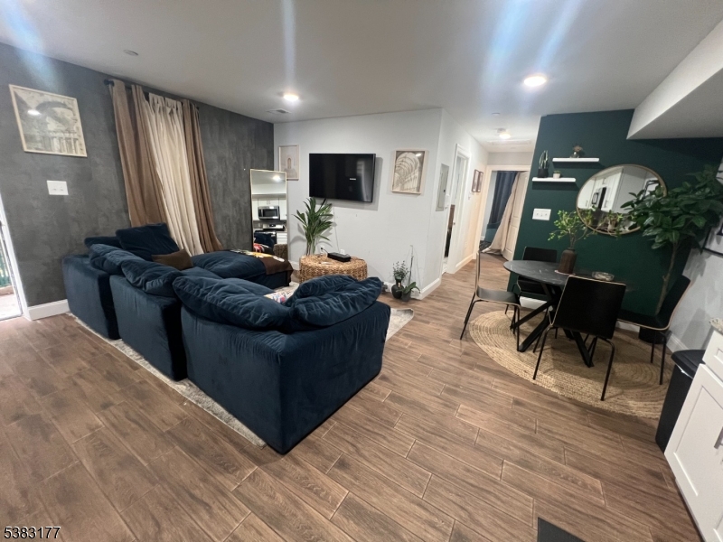 118 Fleming Avenue, Unit 1 Newark, NJ 07105 - Photo 3 of 14 a living room with furniture and a flat screen tv