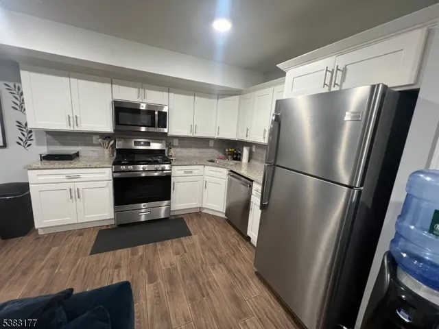 a kitchen with stainless steel appliances a refrigerator sink and cabinets