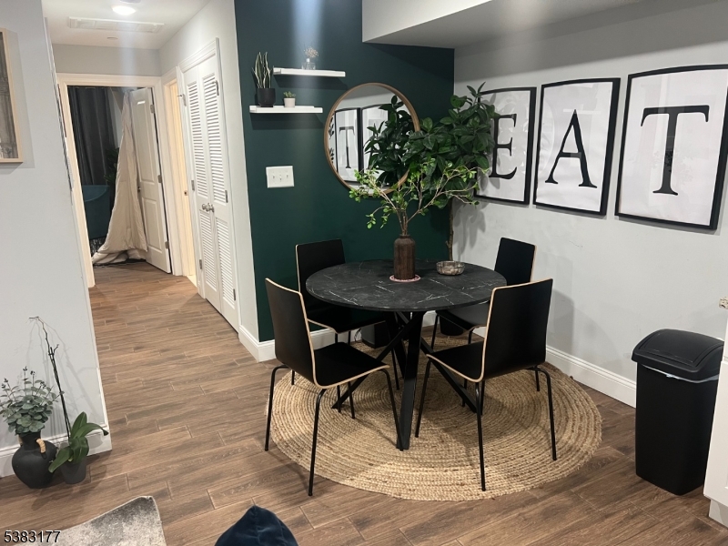118 Fleming Avenue, Unit 1 Newark, NJ 07105 - Photo 7 of 14 a view of a dining room with furniture and wooden floor