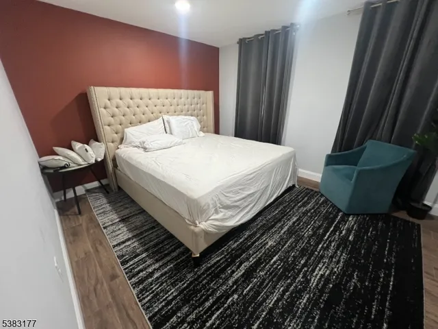 a bedroom with a bed and a rug