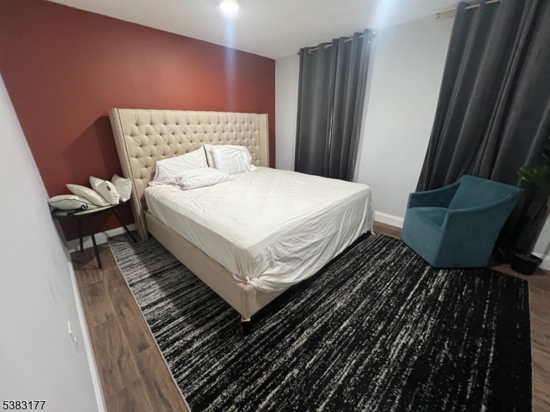 118 Fleming Avenue, Unit 1 Newark, NJ 07105 - Photo 9 of 14 a bedroom with a bed and a rug