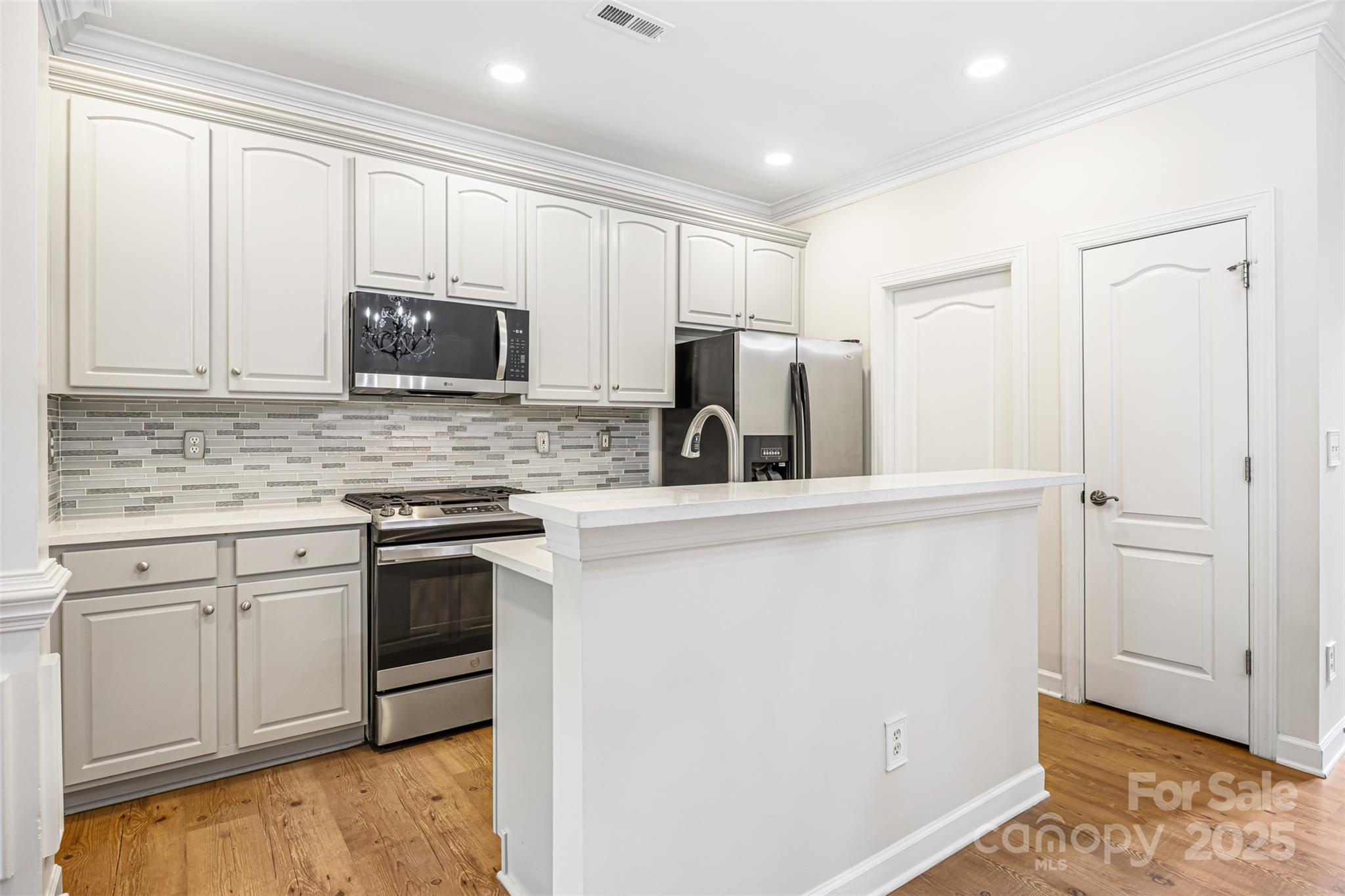 6729 Dusty Saddle Road Charlotte, NC 28277 - Photo 11 of 44 a kitchen with granite countertop white cabinets and stainless steel appliances
