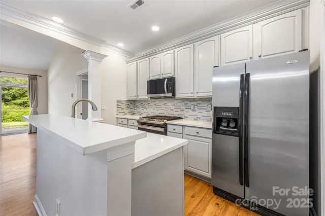 a kitchen with refrigerator and stove