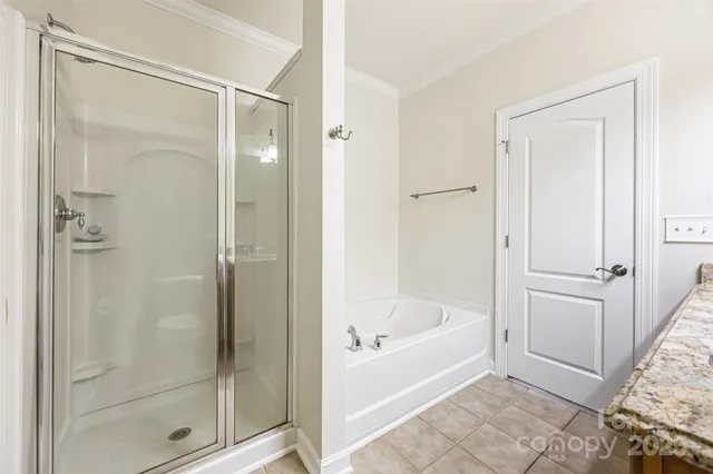 a white bath tub sitting next to a shower