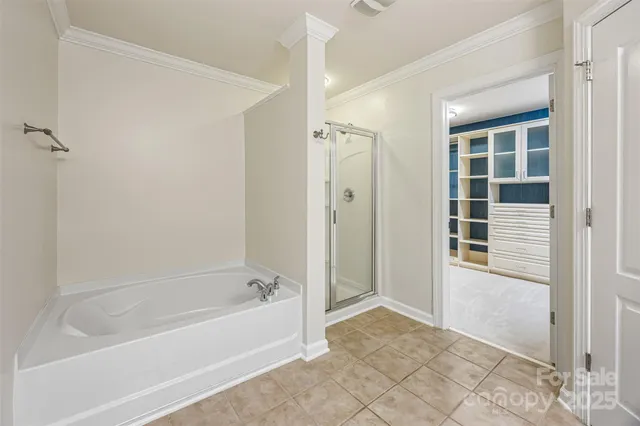 a spacious bathroom with a bathtub and a shower