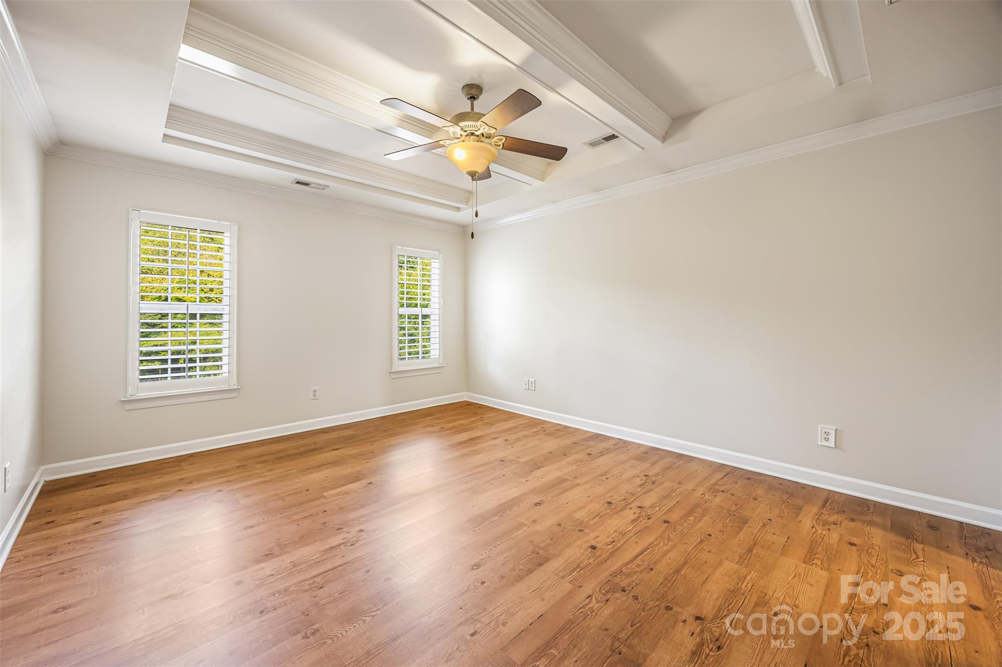 6729 Dusty Saddle Road Charlotte, NC 28277 - Photo 29 of 44 an empty room with wooden floor fan and windows